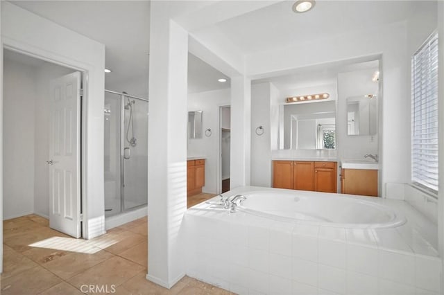 bathroom featuring tile patterned floors, vanity, shower with separate bathtub, and plenty of natural light