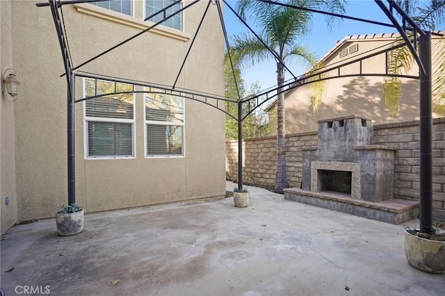 view of patio with an outdoor stone fireplace