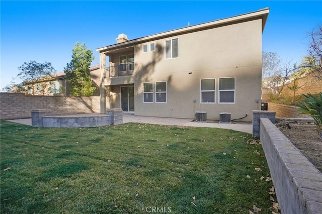 back of property featuring a balcony, a patio, a lawn, and central air condition unit