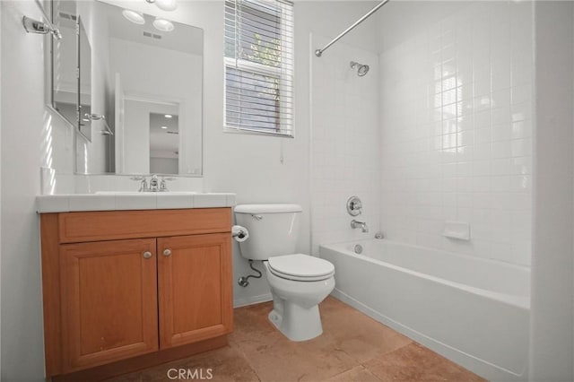 full bathroom featuring vanity, tiled shower / bath combo, tile patterned floors, and toilet