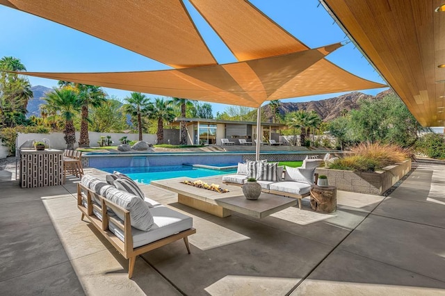 view of pool with an outdoor hangout area, a patio area, and a mountain view