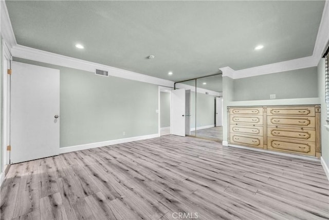 interior space featuring crown molding and light hardwood / wood-style flooring