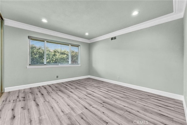 unfurnished room featuring crown molding and light hardwood / wood-style flooring