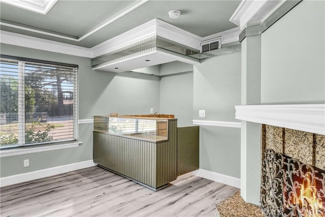 bar featuring light wood-type flooring and crown molding