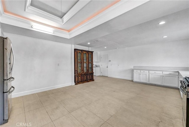 unfurnished room with a raised ceiling and ornamental molding