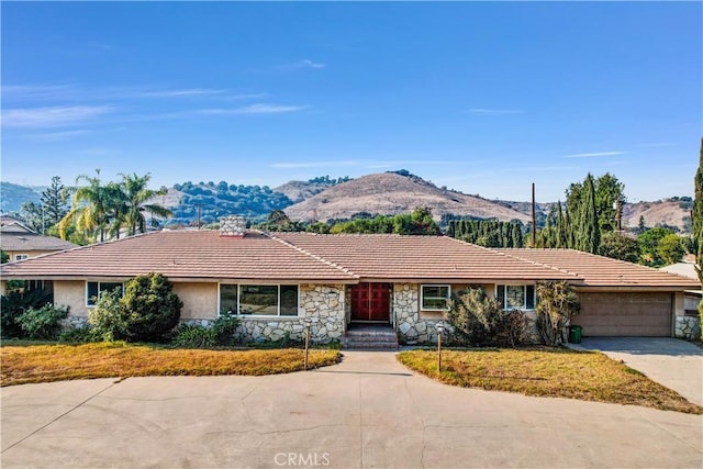 ranch-style home featuring a mountain view and a garage