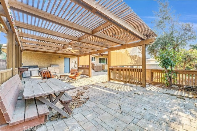 view of patio / terrace featuring a pergola, ceiling fan, and an outdoor kitchen