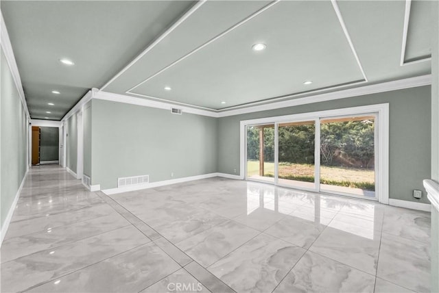 unfurnished room with a raised ceiling and crown molding