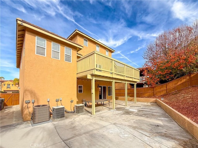 back of property featuring central air condition unit and a patio