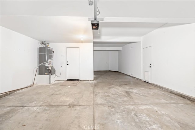 garage with a garage door opener and gas water heater