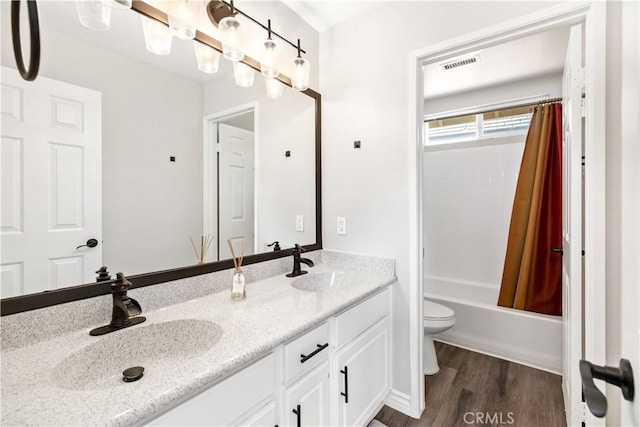 full bathroom with toilet, vanity, wood-type flooring, and shower / tub combo with curtain