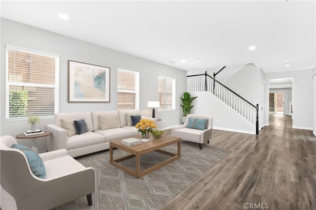 living room with dark hardwood / wood-style flooring and plenty of natural light