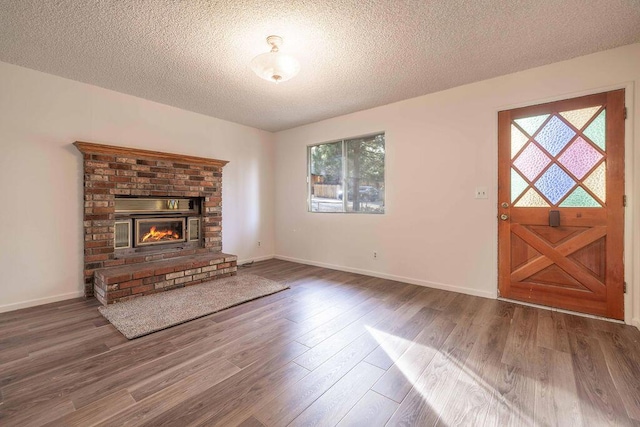 unfurnished living room with a textured ceiling and a wealth of natural light