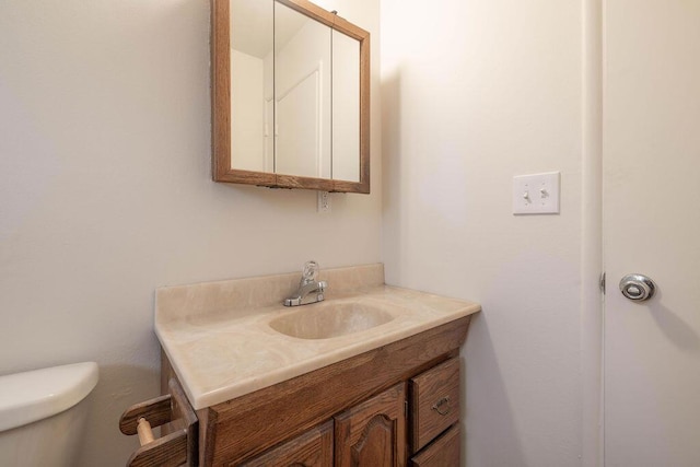 bathroom featuring toilet and vanity