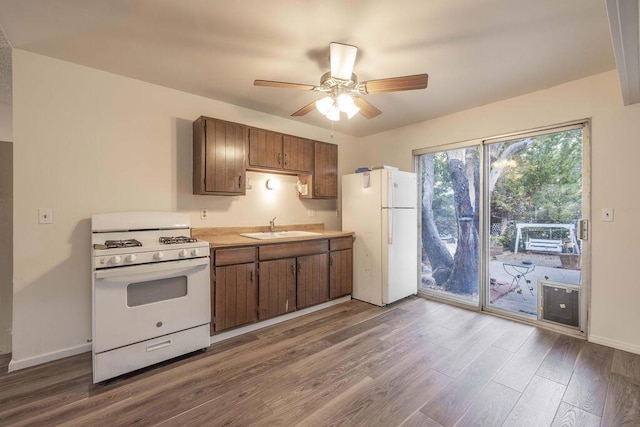 kitchen featuring hardwood / wood-style flooring, sink, white appliances, and ceiling fan