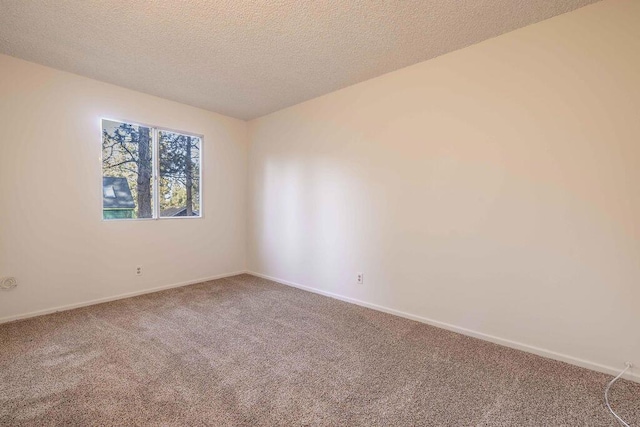 carpeted spare room featuring a textured ceiling