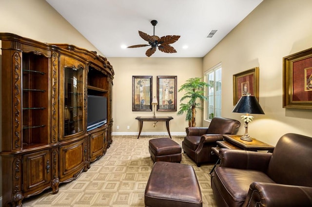 living area featuring ceiling fan and light carpet