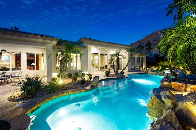 view of pool featuring ceiling fan and a patio area