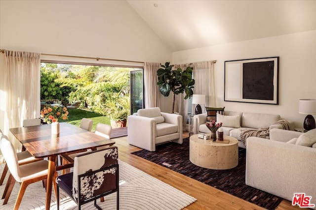 living room with high vaulted ceiling and hardwood / wood-style floors