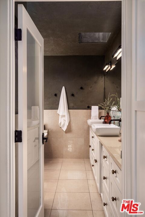 bathroom with tile patterned floors and vanity