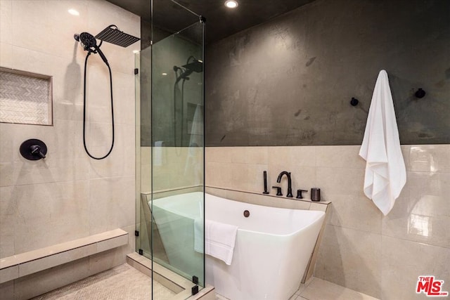 bathroom featuring separate shower and tub