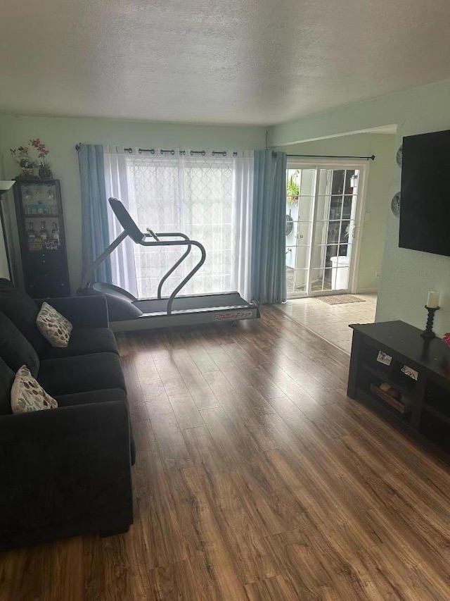 living room with dark hardwood / wood-style flooring and a textured ceiling