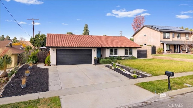 view of front of property with a front lawn, a garage, and solar panels