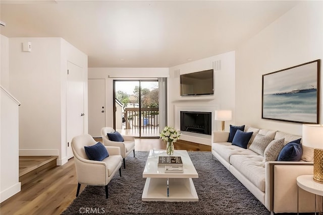 750 Chorro St Unit 5, San Luis Obispo, CA 93401 - living room with wood finished floors, baseboards, and a fireplace with raised hearth