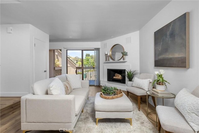 750 Chorro St Unit 5, San Luis Obispo, CA 93401 - living room featuring wood finished floors, baseboards, and a fireplace with raised hearth