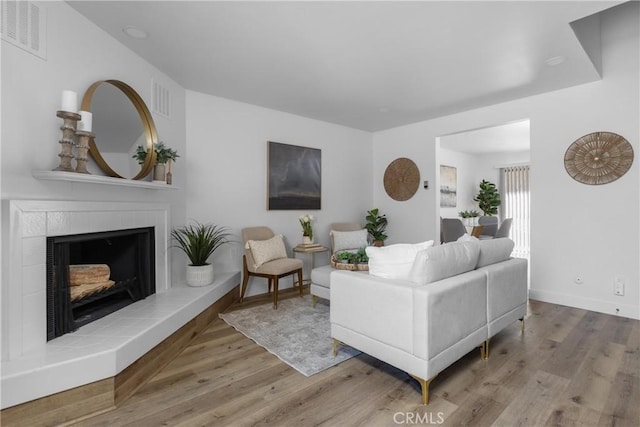 750 Chorro St Unit 5, San Luis Obispo, CA 93401 - living area featuring wood finished floors, a tiled fireplace, and baseboards