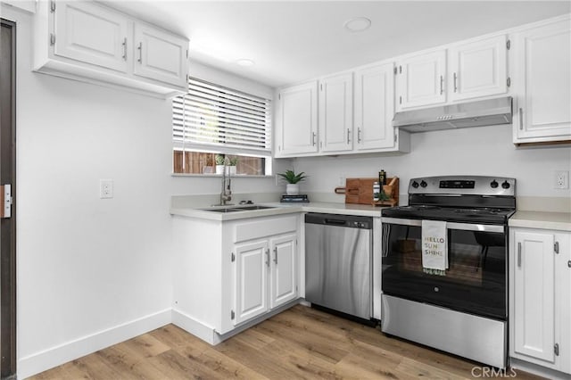 750 Chorro St Unit 5, San Luis Obispo, CA 93401 - kitchen featuring appliances with stainless steel finishes, under cabinet range hood, a sink, light countertops, and white cabinets