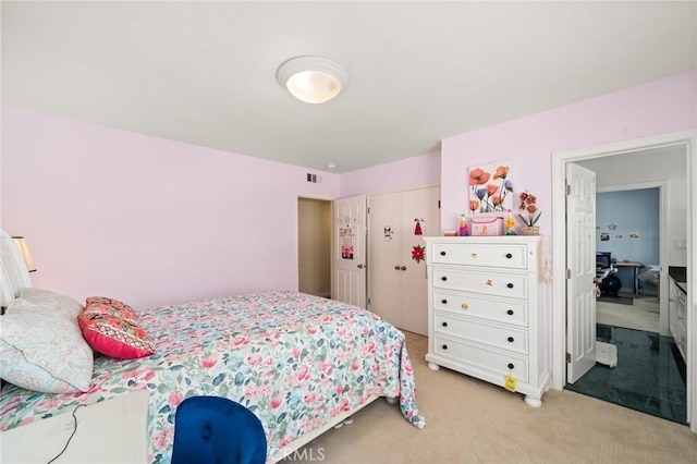 bedroom featuring light colored carpet