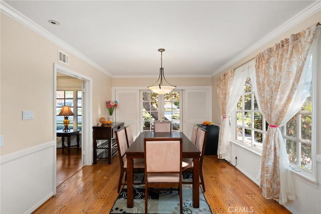 dining room featuring ornamental molding and hardwood / wood-style flooring