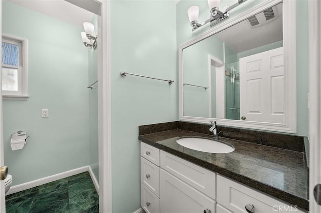 bathroom with toilet and vanity