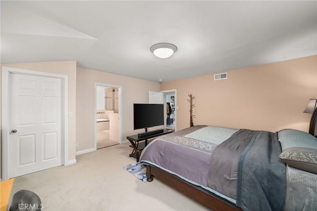 carpeted bedroom featuring connected bathroom