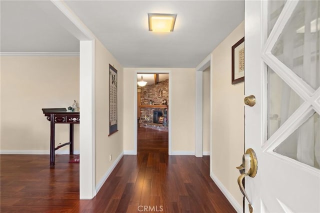 corridor featuring dark hardwood / wood-style flooring and crown molding