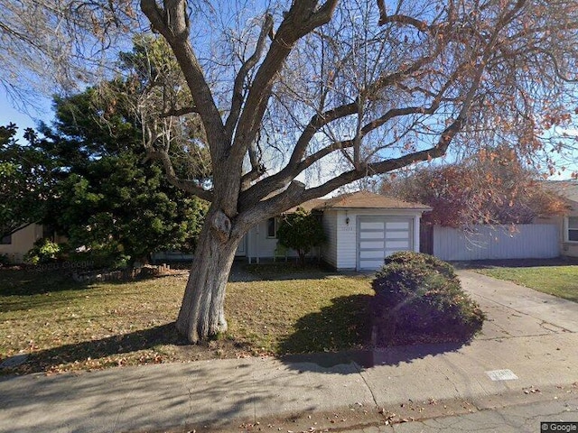 view of front of home with a garage and a front yard