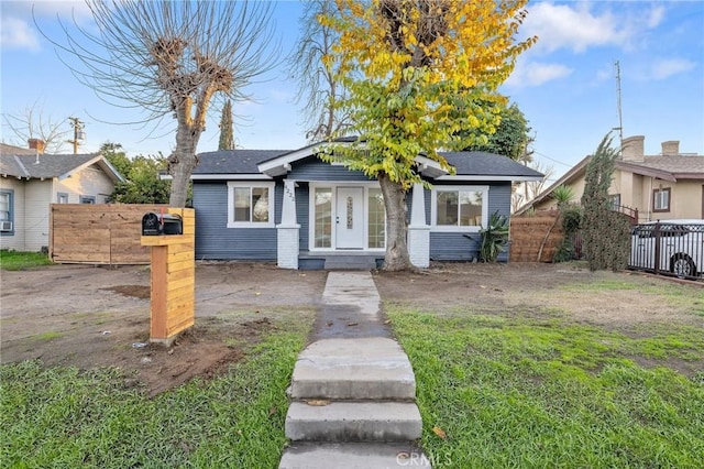 bungalow-style house with a front lawn