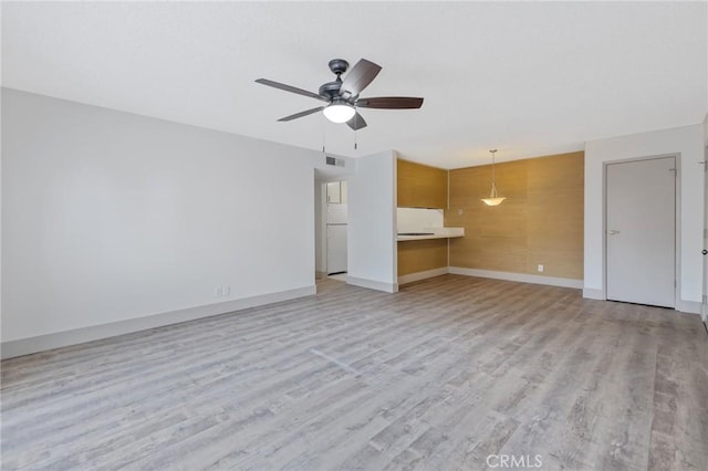 unfurnished living room with light hardwood / wood-style floors and ceiling fan