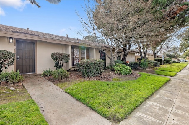 ranch-style house with a front lawn