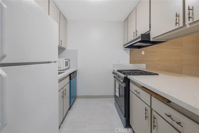 kitchen featuring tasteful backsplash, white cabinetry, light tile patterned flooring, and white appliances