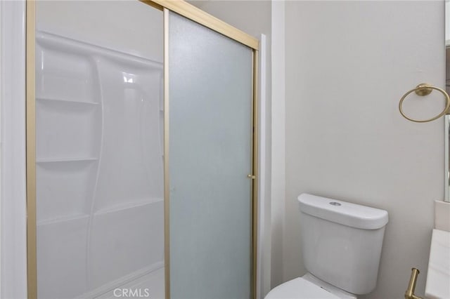 bathroom with walk in shower and toilet