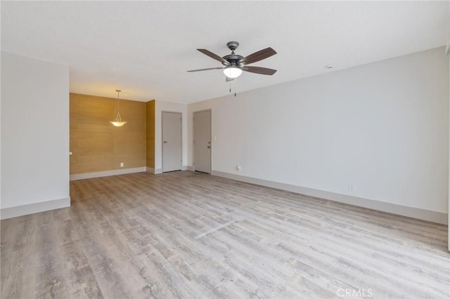 unfurnished room featuring ceiling fan and light wood-type flooring