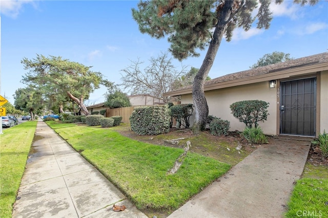 view of side of property with a lawn