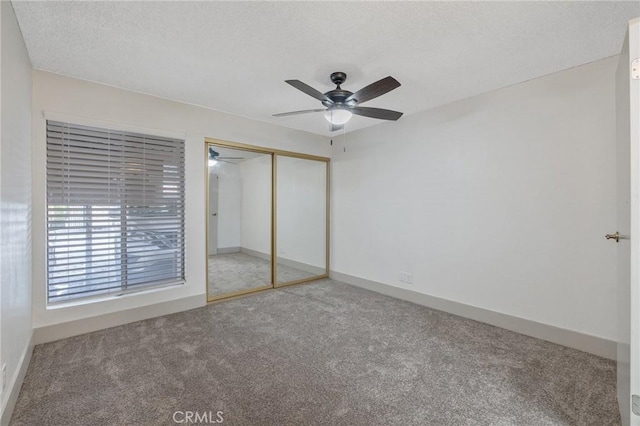 unfurnished bedroom featuring a closet, ceiling fan, and carpet flooring