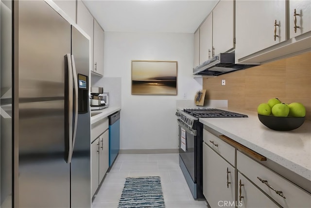 kitchen with stainless steel appliances, light tile patterned floors, decorative backsplash, and white cabinets