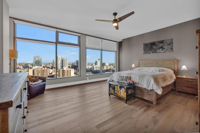 bedroom featuring ceiling fan and light hardwood / wood-style flooring