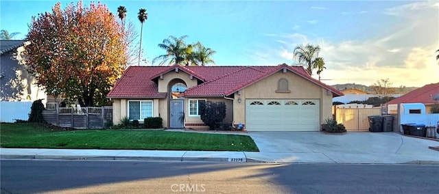 view of front facade featuring a garage and a lawn