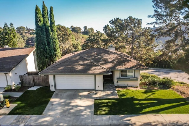 view of front of home with a front lawn and a garage