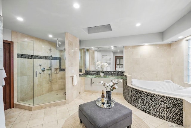 bathroom with plus walk in shower and tile patterned flooring